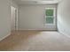 Bedroom with neutral walls, carpet, and a picture window offering natural light at 3517 Mortons Landing Dr, Ellenwood, GA 30294