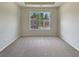 Bright bedroom with neutral carpet and a large window overlooking neighborhood at 3517 Mortons Landing Dr, Ellenwood, GA 30294