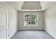 This bedroom features a large window and tray ceiling for a bright and modern feel at 3517 Mortons Landing Dr, Ellenwood, GA 30294