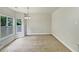 A formal dining room offers lots of natural light and an elegant chandelier at 3517 Mortons Landing Dr, Ellenwood, GA 30294