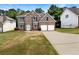 Charming two-story brick home featuring a two-car garage and a well-manicured front lawn at 3517 Mortons Landing Dr, Ellenwood, GA 30294