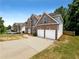 Charming two-story brick home featuring a two-car garage and a well-manicured front lawn at 3517 Mortons Landing Dr, Ellenwood, GA 30294