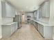 Spacious kitchen featuring light gray cabinets, stainless steel appliances, and tile flooring at 3517 Mortons Landing Dr, Ellenwood, GA 30294