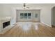 The spacious living room features wood floors and fireplace with view of the fenced in backyard at 3517 Mortons Landing Dr, Ellenwood, GA 30294
