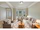 Bright, staged living room featuring hardwood floors and a bay window at 3517 Mortons Landing Dr, Ellenwood, GA 30294