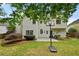 Back exterior of the house features a patio, basketball hoop, and well-maintained lawn at 4360 Canterbury Walk Dr, Duluth, GA 30097