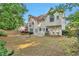 Wide view of a beautiful backyard with healthy green grass, a patio, and shade trees at 4360 Canterbury Walk Dr, Duluth, GA 30097