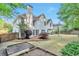 Backyard with healthy green grass, shade trees, a patio, and raised planter beds at 4360 Canterbury Walk Dr, Duluth, GA 30097