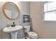 Powder room featuring pedestal sink, modern fixtures and neutral color scheme at 4360 Canterbury Walk Dr, Duluth, GA 30097