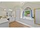Bathroom featuring a chandelier, tub under an arched window and a glass shower at 4360 Canterbury Walk Dr, Duluth, GA 30097