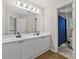 Bright bathroom featuring a double vanity with white cabinets and a large mirror at 4360 Canterbury Walk Dr, Duluth, GA 30097