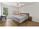 Bedroom featuring wood-look flooring, ceiling fan, and closet wardrobe at 4360 Canterbury Walk Dr, Duluth, GA 30097
