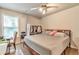 Bedroom featuring a queen bed, desk, ceiling fan and window providing ample natural light at 4360 Canterbury Walk Dr, Duluth, GA 30097