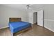 Bedroom showcasing wood floors, ceiling fan and a double door closet at 4360 Canterbury Walk Dr, Duluth, GA 30097