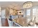 Bright dining area with modern chandelier, table, and chairs, next to a kitchen with stainless appliances at 4360 Canterbury Walk Dr, Duluth, GA 30097