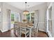 Cozy dining room featuring wood flooring, modern chandelier, and large windows offering plenty of natural light at 4360 Canterbury Walk Dr, Duluth, GA 30097
