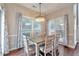 Cozy dining area with ample natural light, wood floors, and stylish chandelier at 4360 Canterbury Walk Dr, Duluth, GA 30097