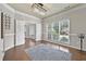 Open dining area with hardwood floors, a modern light fixture, and serene views of the outdoors at 4360 Canterbury Walk Dr, Duluth, GA 30097