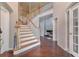 Elegant foyer with hardwood floors, staircase, and view into a living room at 4360 Canterbury Walk Dr, Duluth, GA 30097