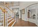 Open foyer area highlighting hardwood floors, staircase, and a view into the adjacent living spaces at 4360 Canterbury Walk Dr, Duluth, GA 30097
