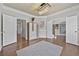 Inviting foyer features wood floors, an elegant light fixture, and classic architectural details, creating a warm welcome at 4360 Canterbury Walk Dr, Duluth, GA 30097