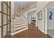 Grand foyer features hardwood floors, a sweeping staircase, and views into the living room at 4360 Canterbury Walk Dr, Duluth, GA 30097