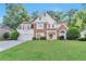 Charming two-story home with manicured lawn, stone accents, and a two-car garage at 4360 Canterbury Walk Dr, Duluth, GA 30097