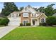 Charming two-story home featuring stone accents, a well-manicured lawn, and a two-car garage at 4360 Canterbury Walk Dr, Duluth, GA 30097