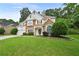 Attractive home with stone facade, mature landscaping, and a double garage on a green lawn at 4360 Canterbury Walk Dr, Duluth, GA 30097