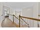 Upstairs hallway with wood floors and white railings, leading to bedrooms at 4360 Canterbury Walk Dr, Duluth, GA 30097
