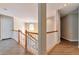 Bright upstairs hallway with white railings and wood flooring, leading to various rooms in the home at 4360 Canterbury Walk Dr, Duluth, GA 30097