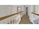 Upstairs hallway with white railings and wood floors, connecting rooms at 4360 Canterbury Walk Dr, Duluth, GA 30097