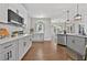 Stylish kitchen with stainless steel appliances, light gray cabinets, quartz countertop, and hardwood flooring throughout at 4360 Canterbury Walk Dr, Duluth, GA 30097
