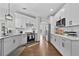 Bright kitchen featuring stainless steel appliances, quartz countertops, tile backsplash, and hardwood flooring at 4360 Canterbury Walk Dr, Duluth, GA 30097