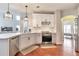 Bright kitchen featuring stainless appliances, white cabinetry, hardwood floors, and modern pendant lighting at 4360 Canterbury Walk Dr, Duluth, GA 30097