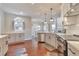 Spacious kitchen with white and grey cabinetry, stainless appliances, and hardwood floors with an adjacent dining area at 4360 Canterbury Walk Dr, Duluth, GA 30097