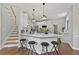 Open-concept kitchen showcasing modern white cabinetry, stainless steel appliances, and a breakfast bar with barstool seating at 4360 Canterbury Walk Dr, Duluth, GA 30097
