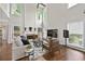 Bright living room featuring a fireplace, hardwood floors, and large windows at 4360 Canterbury Walk Dr, Duluth, GA 30097