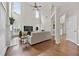 Bright living room with soaring ceilings, large windows, a cozy fireplace, and gleaming hardwood floors throughout at 4360 Canterbury Walk Dr, Duluth, GA 30097