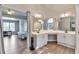 Bright bathroom featuring a double vanity, mirrors, and view into the spacious main bedroom at 4360 Canterbury Walk Dr, Duluth, GA 30097