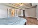 Large main bedroom with tray ceiling, ceiling fan, wood floors, and ensuite bathroom at 4360 Canterbury Walk Dr, Duluth, GA 30097
