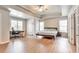 Spacious main bedroom featuring tray ceiling, ceiling fan, wood floors, desk area, and natural light at 4360 Canterbury Walk Dr, Duluth, GA 30097
