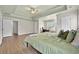 Spacious primary bedroom with trey ceilings, wood floors, desk and an en suite bathroom at 4360 Canterbury Walk Dr, Duluth, GA 30097