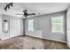 Spacious bedroom with neutral walls, a ceiling fan, and natural light from the two windows at 1417 Poplar Pointe Se, Smyrna, GA 30082