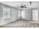 Bedroom featuring neutral walls, two windows with blinds, and a ceiling fan at 1417 Poplar Pointe Se, Smyrna, GA 30082