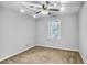 Bedroom with a ceiling fan, window and neutral colored carpet and walls at 1417 Poplar Pointe Se, Smyrna, GA 30082