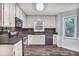 Functional kitchen with white cabinetry, dark appliances, and ample counter space at 1417 Poplar Pointe Se, Smyrna, GA 30082
