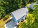 Aerial view of home with lush, mature trees, attached garage, and long private drive at 1428 Brookcliff Dr, Marietta, GA 30062