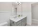 Bathroom featuring dual sink vanity with gray cabinets, white walls, and silver faucets at 1428 Brookcliff Dr, Marietta, GA 30062