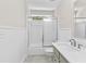 Bathroom featuring a shower with sliding door, white tiled walls, and a gray vanity at 1428 Brookcliff Dr, Marietta, GA 30062